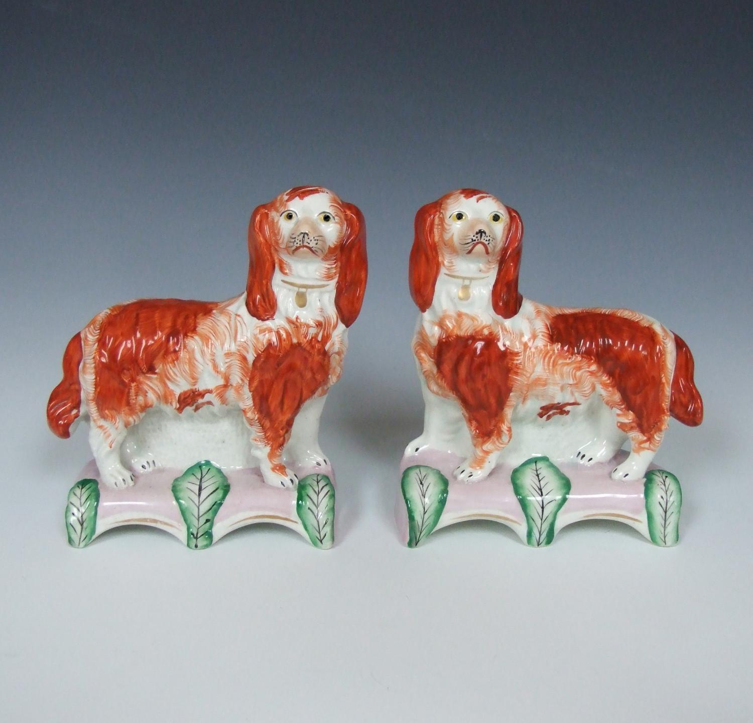 Pair Staffordshire spaniels on pink cushions