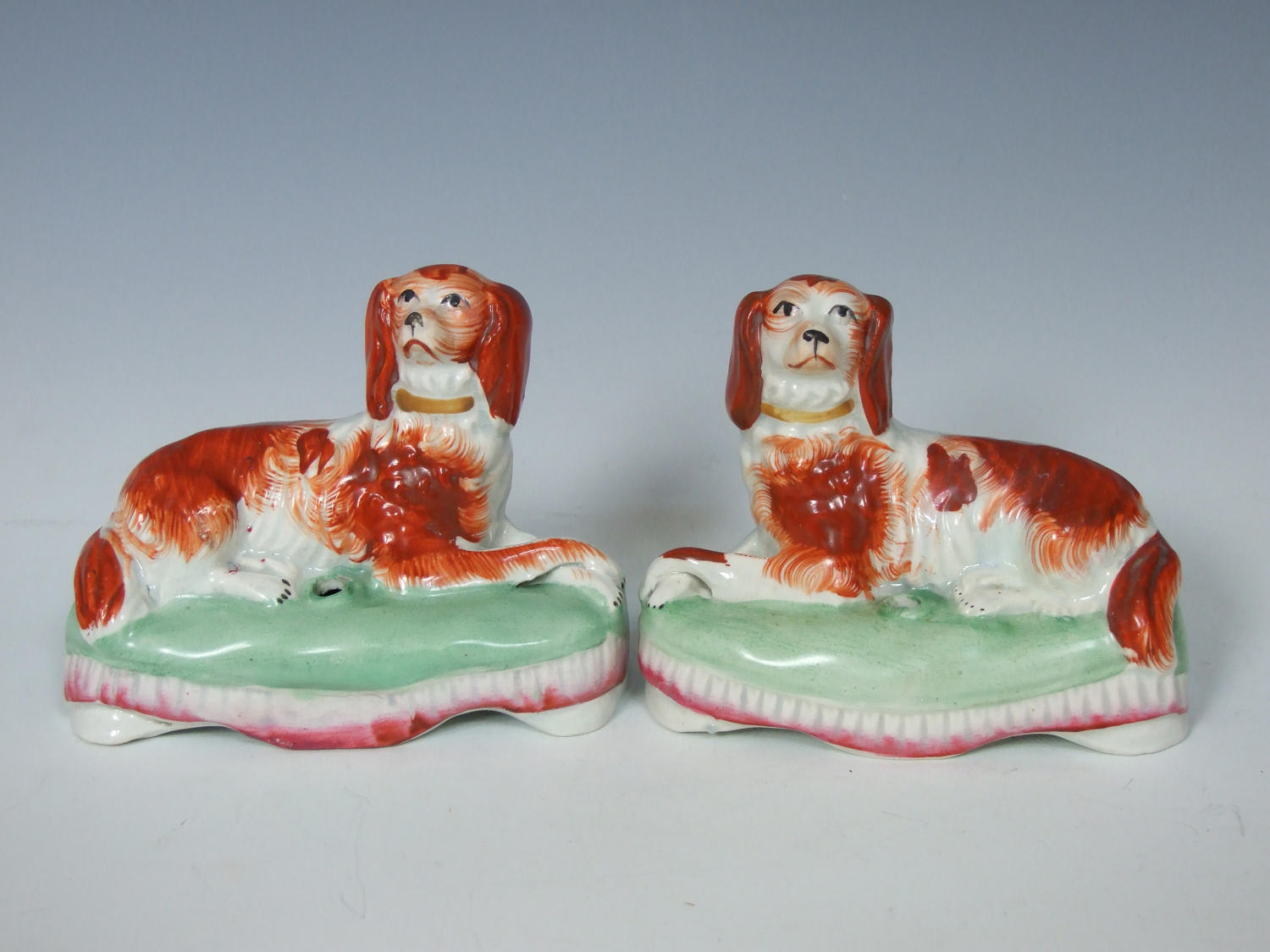 Pair of rare Staffordshire setters on cushions