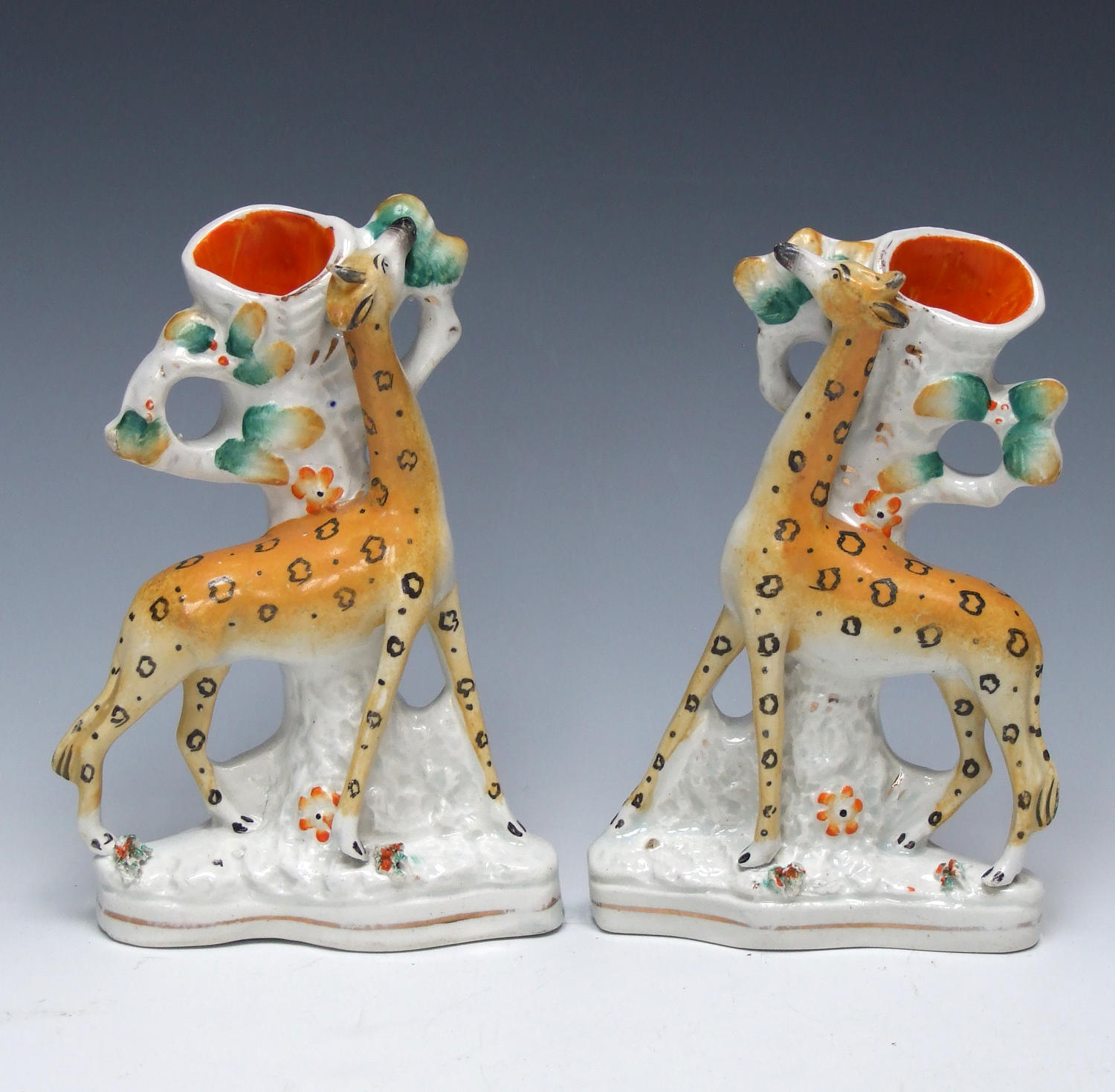 Extremely rare pair of Staffordshire standing giraffe spills
