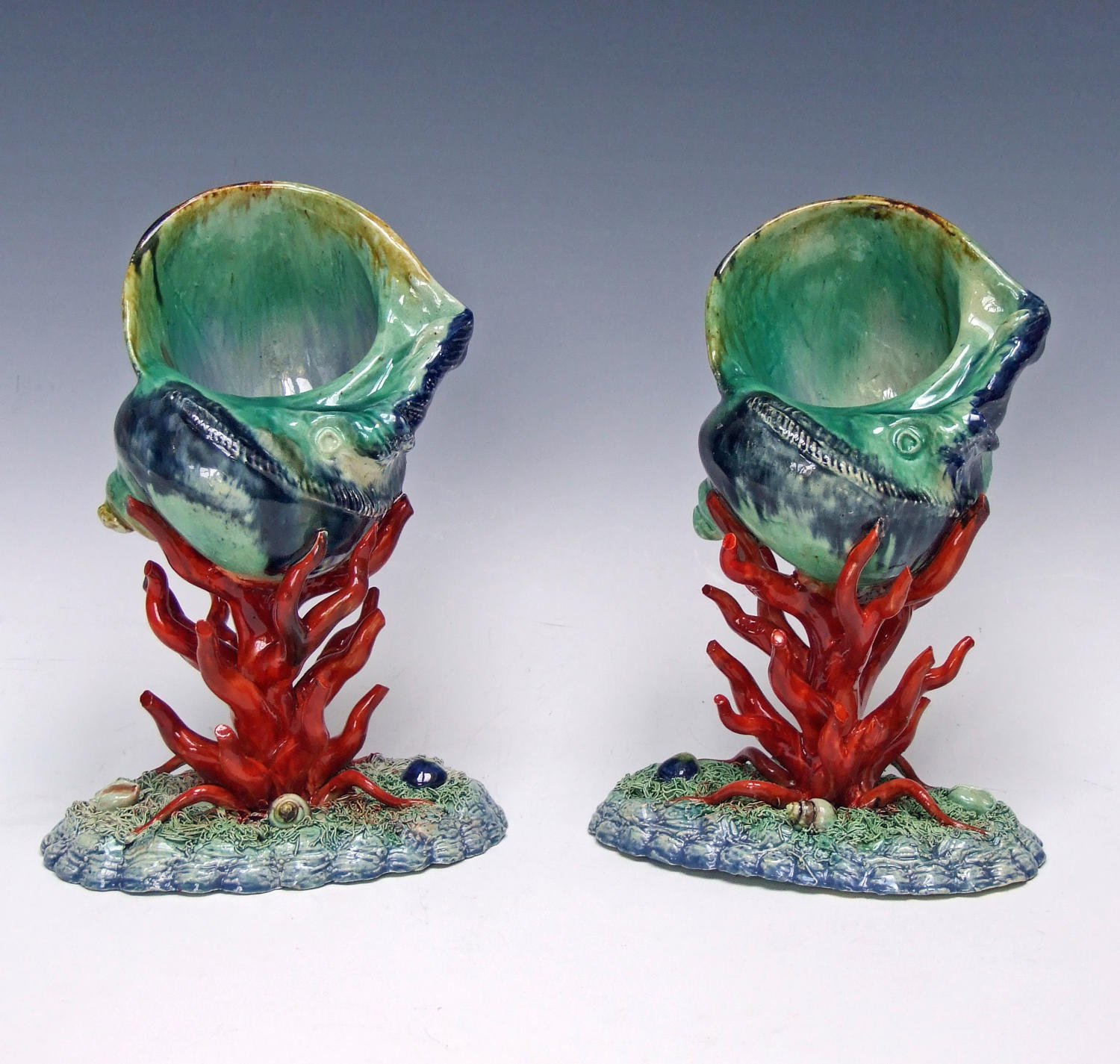 Pair of Palissy shell vases on coral stands