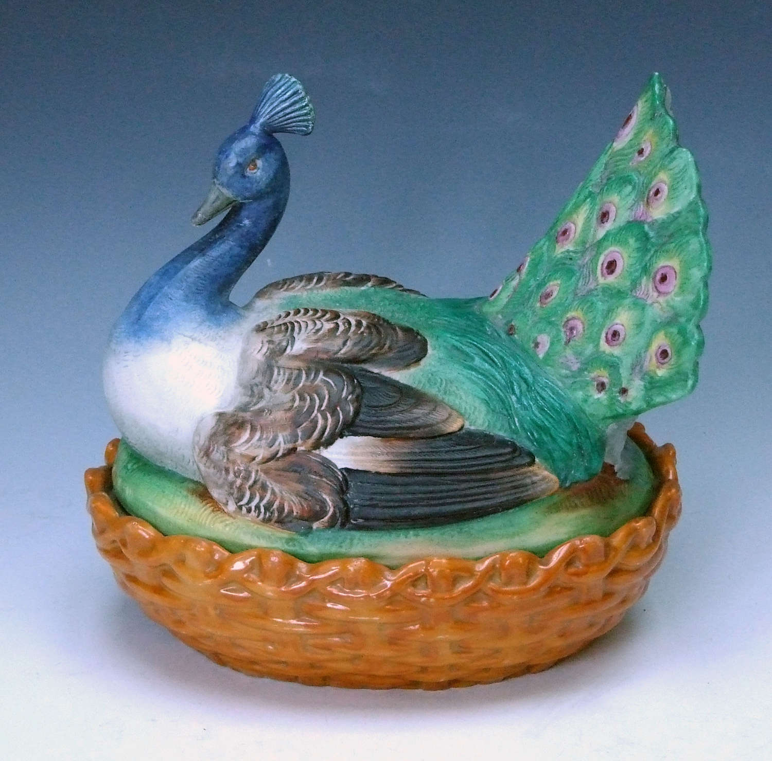 A uniquely rare painted bisque peacock motif tureen and cover