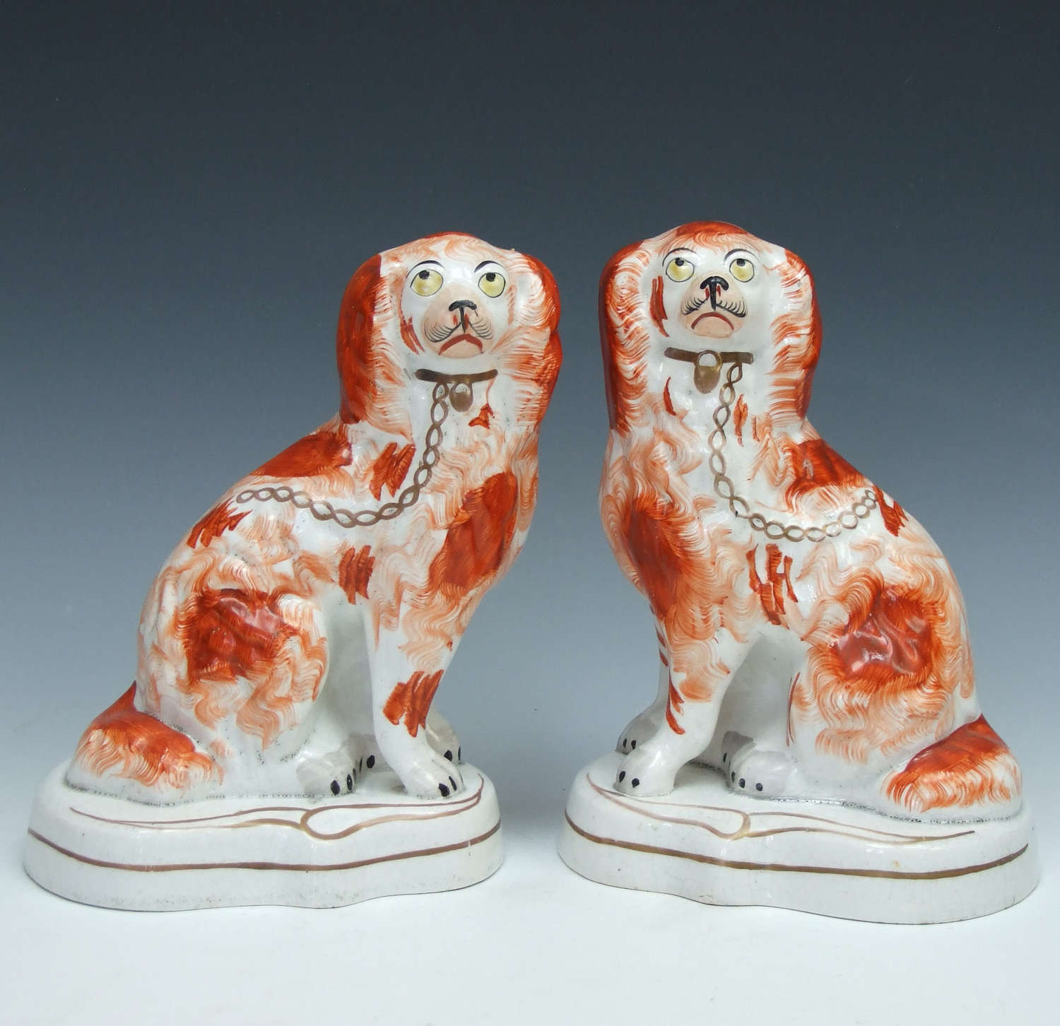 Fine pair of early Staffordshire spaniel figures on shaped raised base