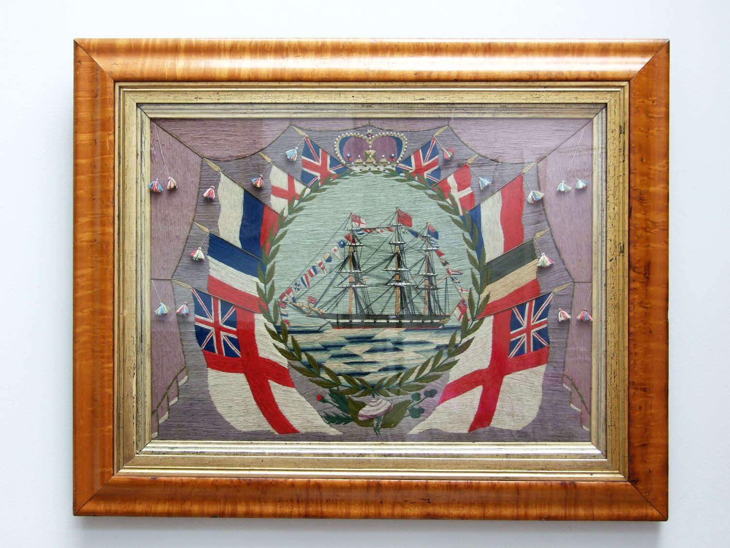 Exceptional sailor's woolwork picture in maple frame.