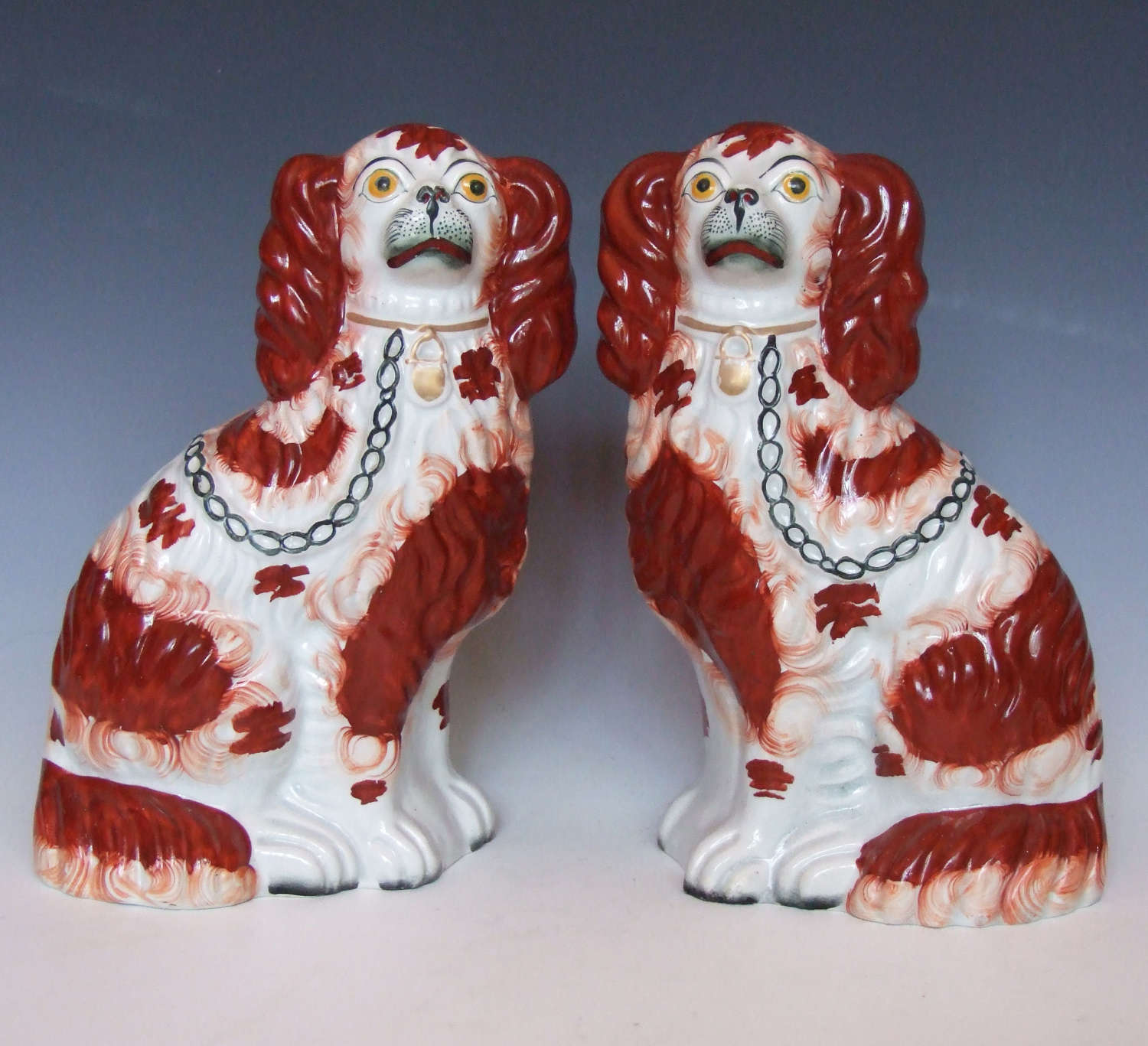Fine pair of red and white Staffordshire spaniel figures.
