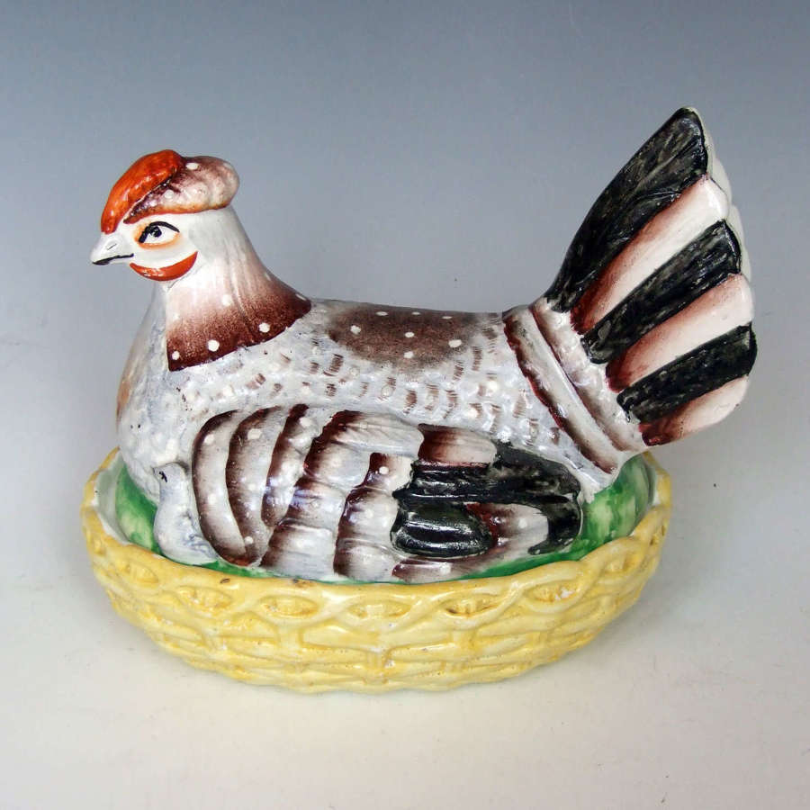 Charming Staffordshire hen with peeping chicks tureen on yellow base.