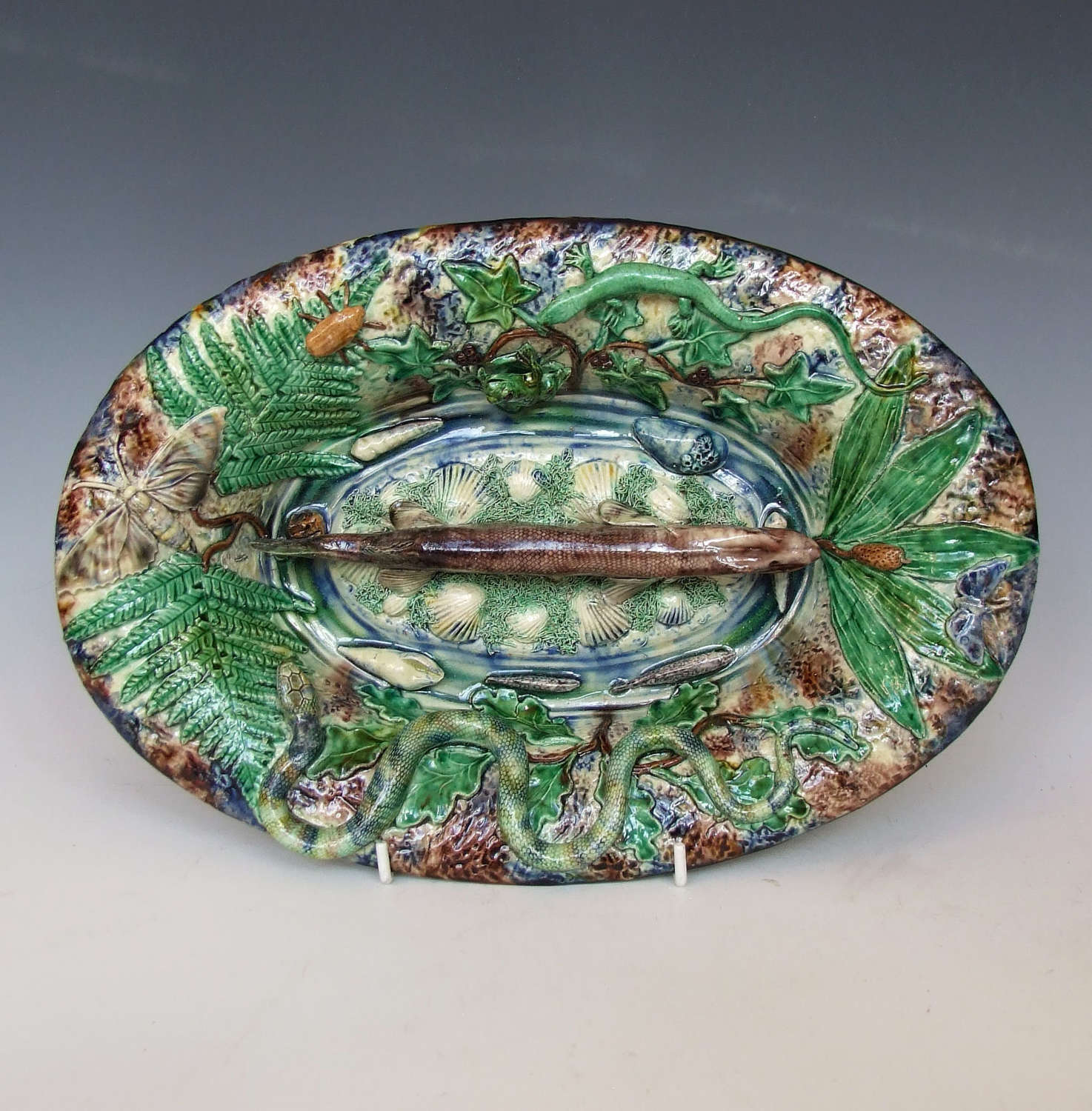 A beautiful French Palissy oval charger with central figure of a pike.
