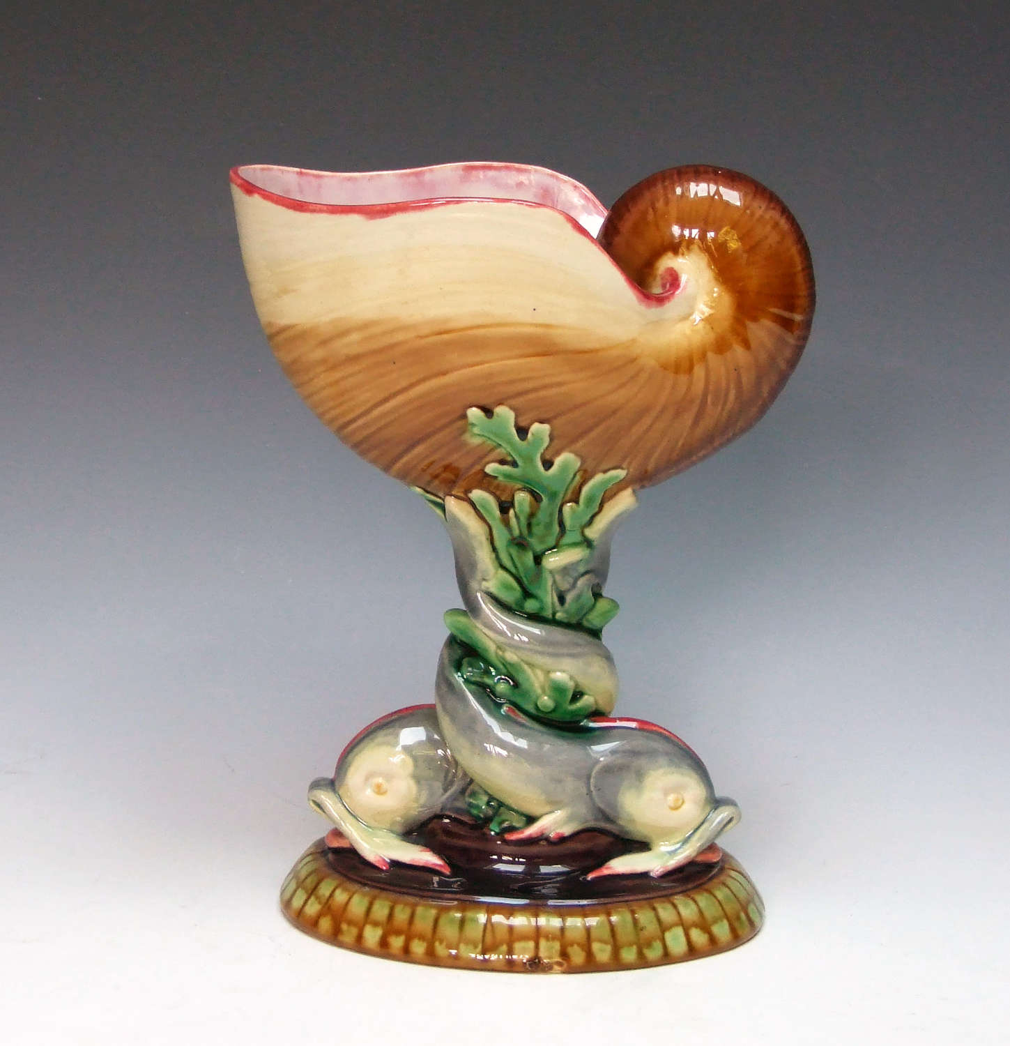 A beautiful Minton majolica nautilus shell and dolphin coupe.