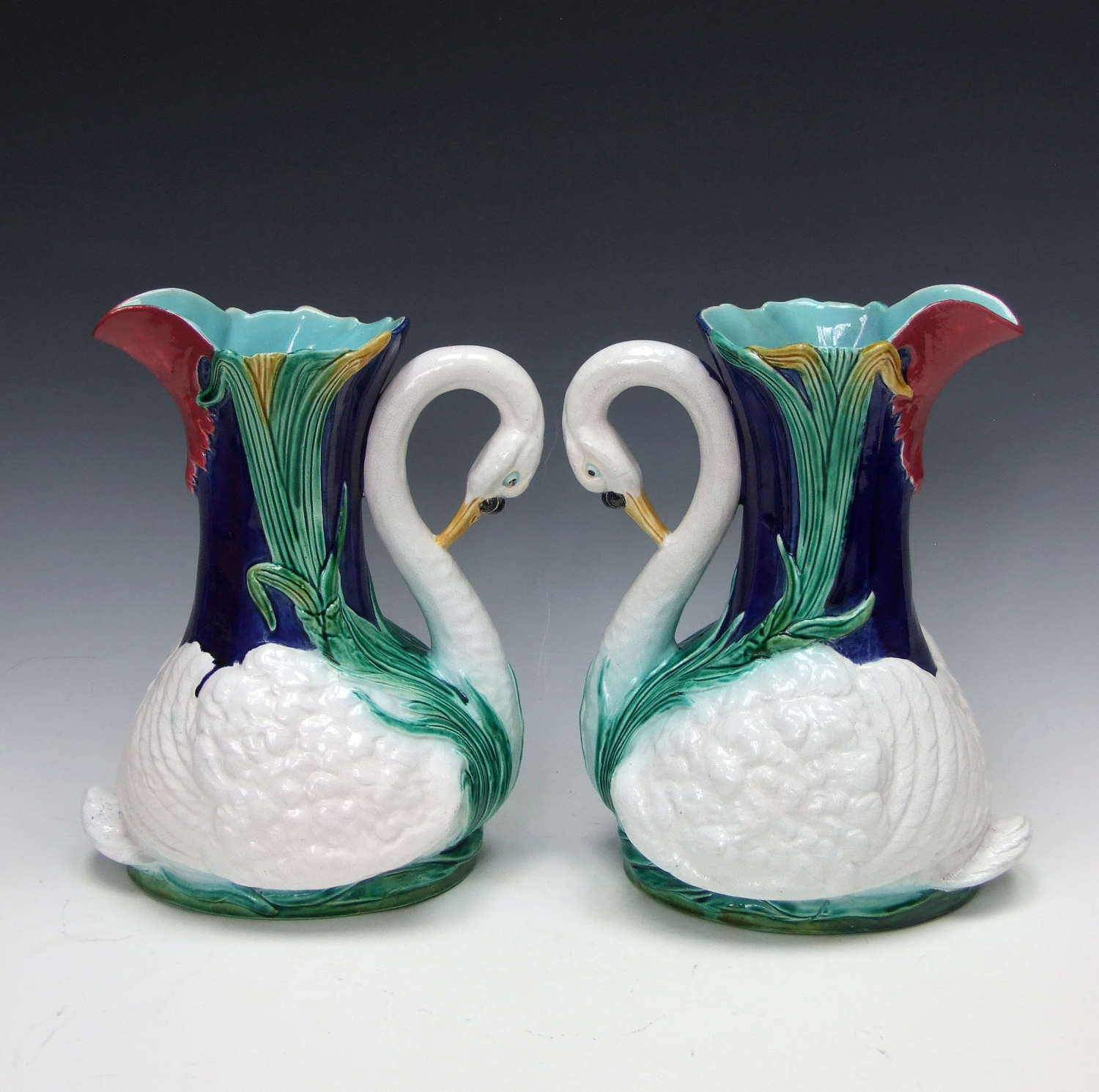 Very rare and unusual pair of Holdcroft majolica swan motif pitchers